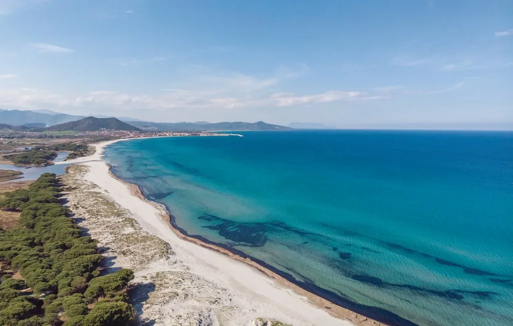 La lunga spiaggia di Marina di Orosei vista dall'alto, tra pinete e mare turchese